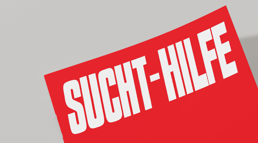 Plakat mit dem Schriftzug „Sucht-Hilfe“ unterstützt von Atelier Türke.