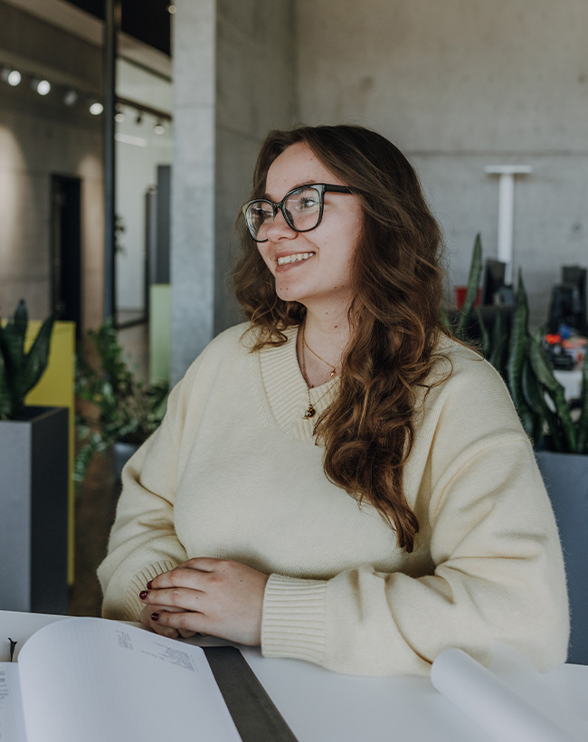 Leona Wolf, Praktikantin im Grafikdesign bei Atelier Türke, im Gespräch mit Kollegen im Büro.