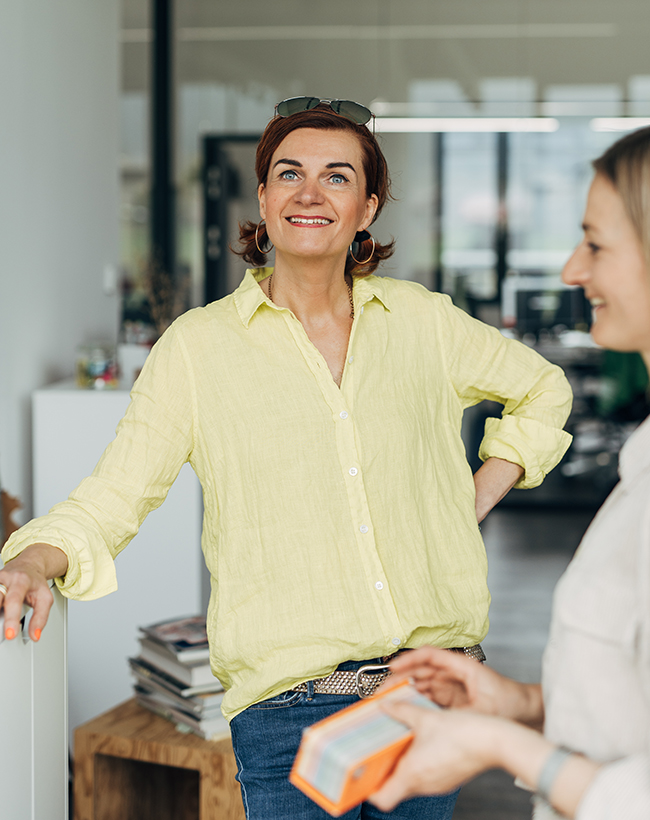 Steffi Eschler, Designerin für Messedesign und Innenarchitektur bei Atelier Türke, im Gespräch mit einer Kollegin
